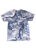 A short-sleeve crewneck t-shirt featuring a blue, gray, and white tie-dye pattern with white zig-zag lines resembling river deltas or cracks. The word 'dreamer' is printed in white across the chest.